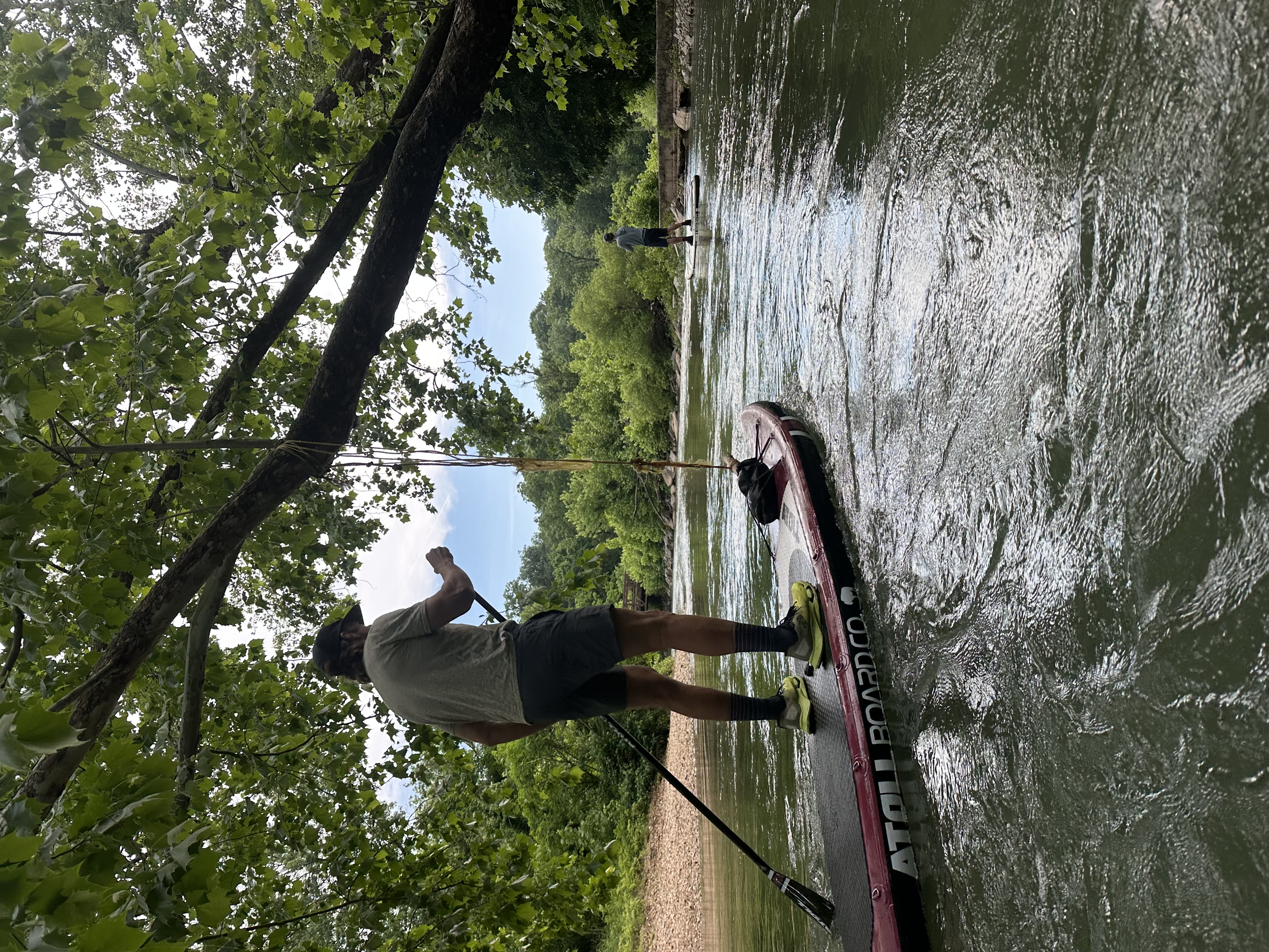 A paddler standing on a SUP board on Little Sugar Creek