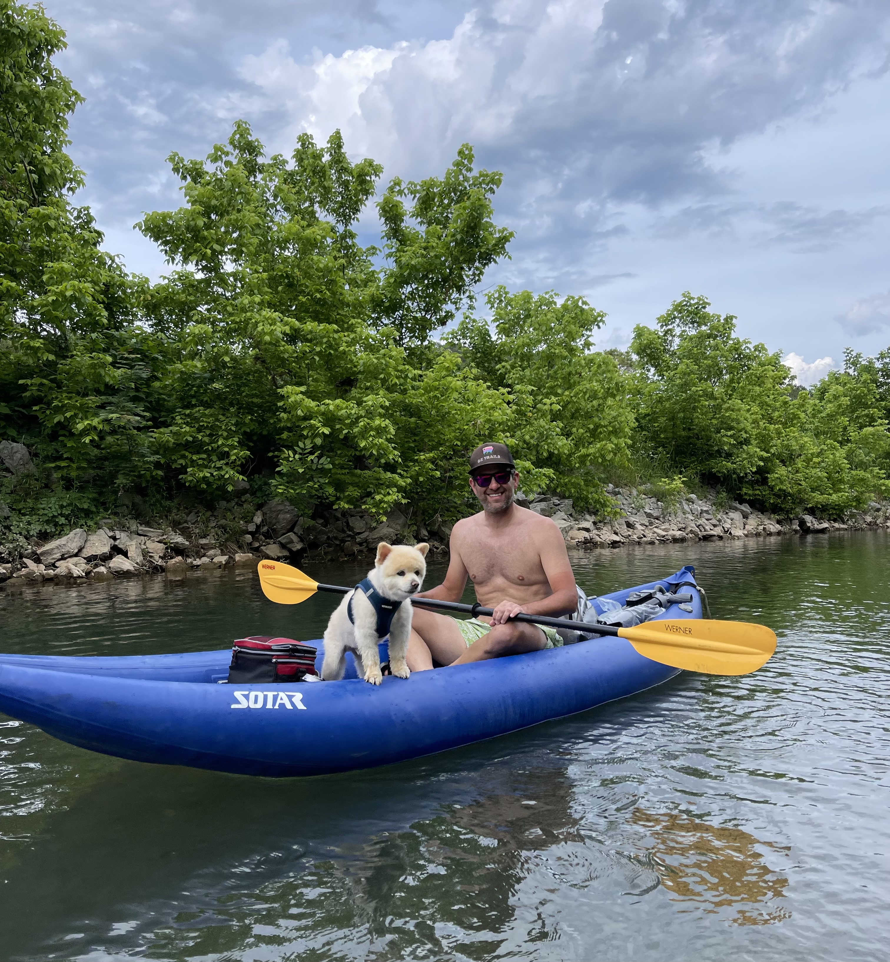 Two paddlers sitting in an inflatable kayak on Little Sugar Creek