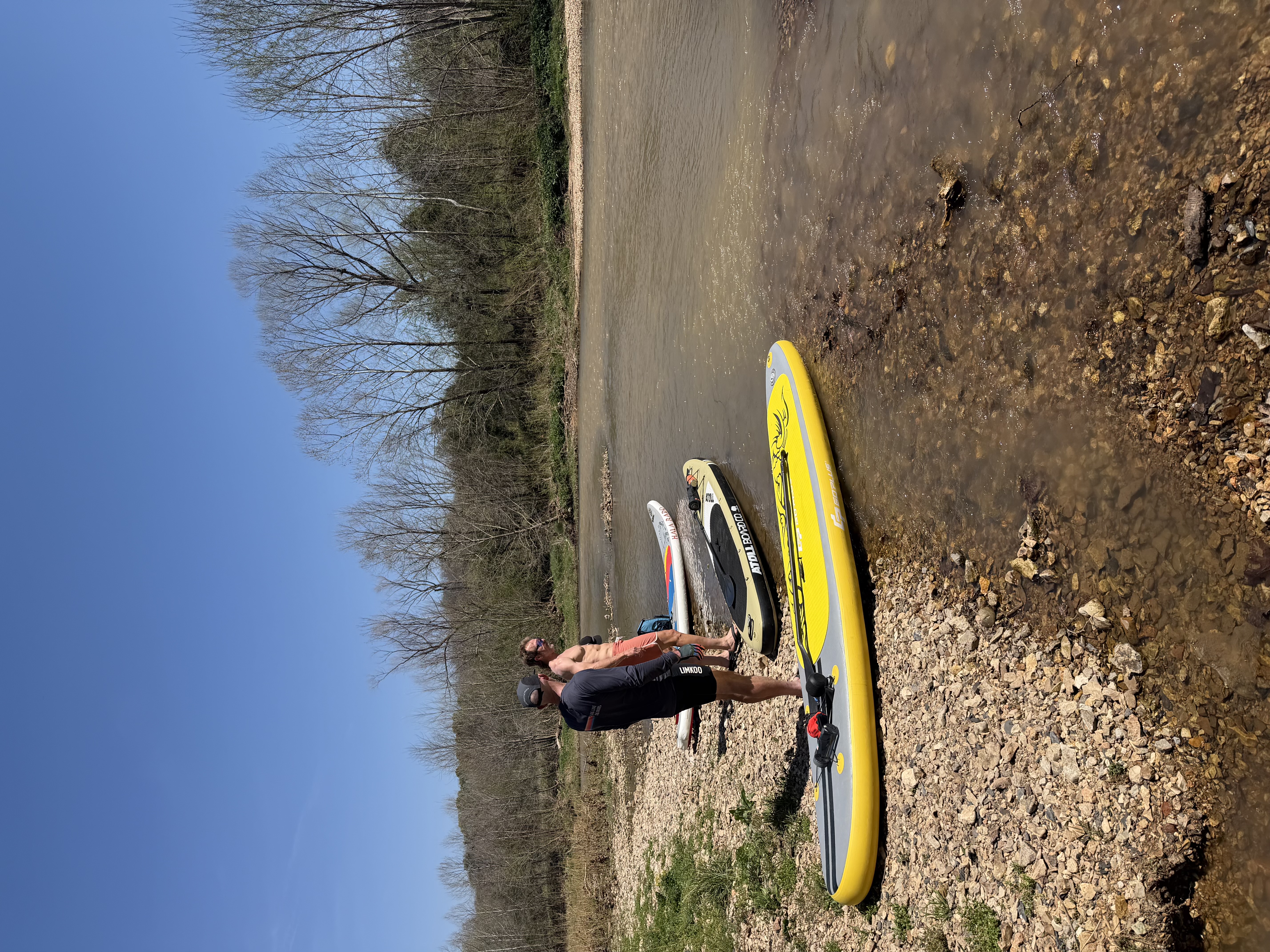 Two paddlers together on the shore of Little Sugar Creek