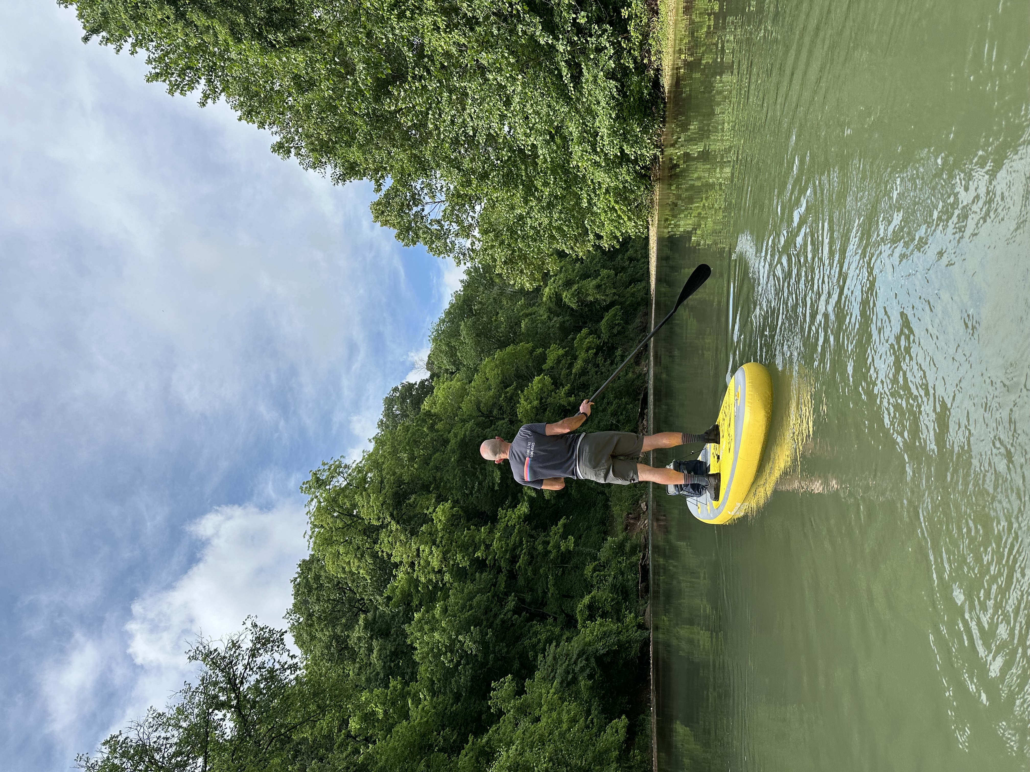 A paddler standing up on a SUP board on Little Sugar Creek